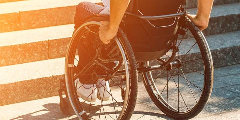 an ndis participant in a wheelchair facing a challenge